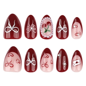 Burgundy and pink almond press-on nails with bow, cherry, and heart 3D nail art design