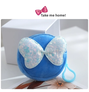 Close-up of blue plush coin purse with colorful sequin bow and plastic hook