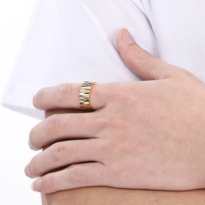 Close-up of wide two-tone stainless steel ring with flame texture on male model