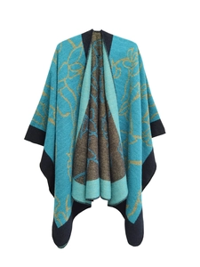 Detailed view of teal and brown floral jacquard knit shawl with black stitched edges
