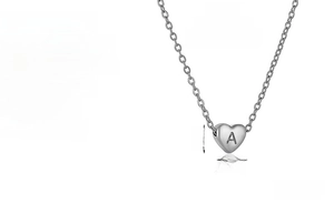 Detail of 18k plated stainless steel heart pendant featuring engraved letter A charm