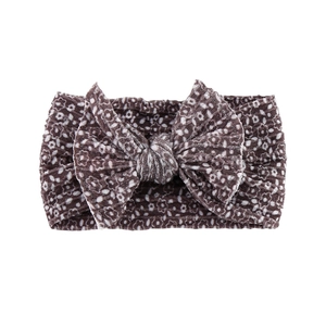 Detail of brown floral print baby headband with a soft ribbed fabric and large bow
