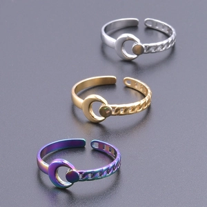 Detailed view of crescent moon and chain rings in silver, gold, and rainbow metallic finishes