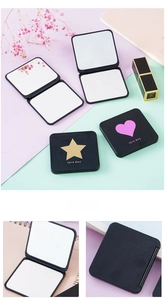 Detail of portable double-sided folding makeup mirror with heart and star patterns