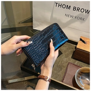 Detail of black crocodile texture women long wallet with golden zipper closure