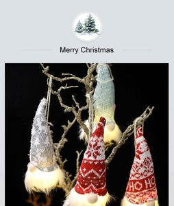Detail of glowing Christmas gnome ornament with warm light and knit fabric texture