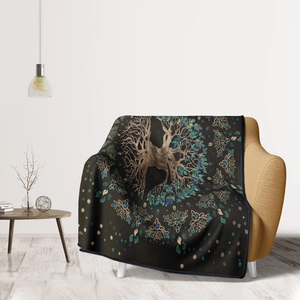 Detail showing the Tree of Life pattern and soft flannel texture of the cozy sofa blanket