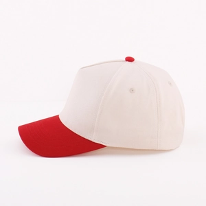 Detail view of cotton five-panel baseball cap with red brim and beige crown contrast