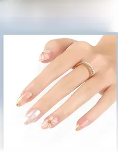 Detailed close-up of 3D floral press-on nails with pearl accents and gold foil lines