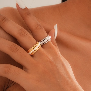 Detailed view of hollow lace pearl rings in gold and silver finish on finger