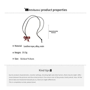 Detailed view of red resin bow pendant with black leather cord and product specifications