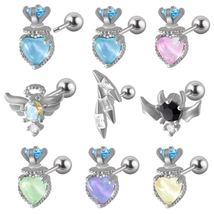 Detailed grid of silver piercing studs with colorful zircon in heart and wing shapes