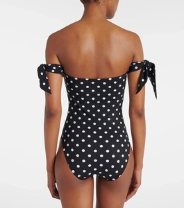 Rear view detail of a black polka dot strapless swimsuit with adjustable shoulder bow ties