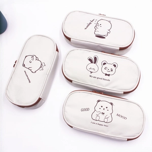 Flat lay of four high-capacity Oxford cloth pencil cases with cute bear illustrations