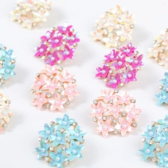 Detail of floral jewelry charms with pearls and rhinestones in various pastel colors