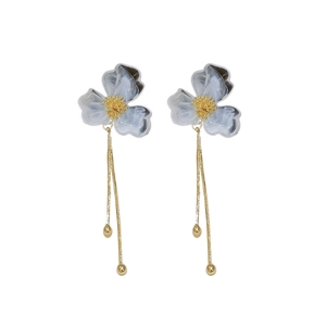 Elegant white acrylic flower tassel earrings with golden chains on white background