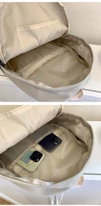Internal view of beige canvas backpack showing organized storage compartments and pockets
