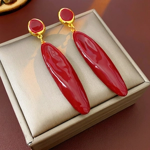 Boucles d'oreilles pendantes ovales en émail rouge foncé et finition dorée élégante