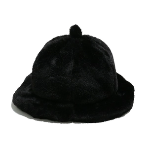 Close-up of black plush bucket hat featuring a pom-pom top and elegant ruffled edges