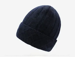 Close-up side view of navy blue knitted beanie hat featuring a diamond metal pin