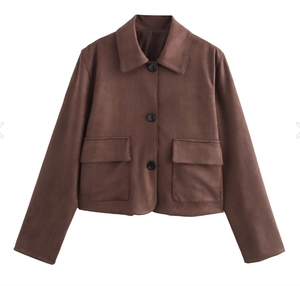Detail of a brown faux suede cropped jacket with large lapels and buttoned flap pockets