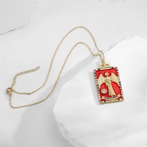 Detail of gold angel tarot pendant with red enamel inlay and colorful cubic zirconia