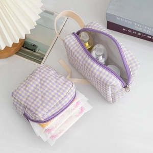 Macro detail of purple checkered quilted fabric cosmetics bag set with zipper and handle