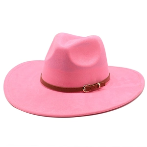 Detailed view of the bright pink suede fedora hat with a brown faux leather belt buckle strap