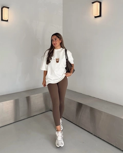 Détail d'un t-shirt à épaules tombantes avec imprimé 'ANOTHER Coffee' et legging taille haute
