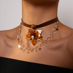 Detail of vintage flower choker with resin petals and gold butterfly charms on model