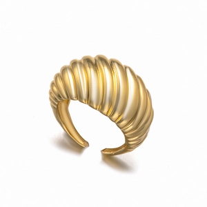 Minimalist gold-plated croissant dome ring with grooved texture on a white background