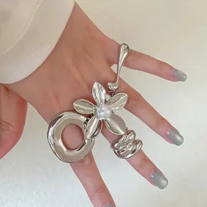 Silver flower ring with pearl and liquid metal style band for a trendy minimalist look