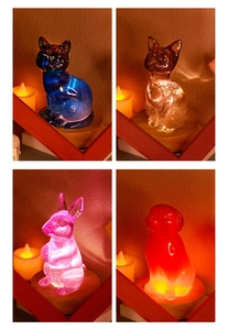Macro detail of animal shaped resin LED night lights with glitter on round wooden bases