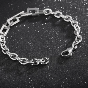 Macro detail of stainless steel link bracelet with geometric rectangular and oval rings