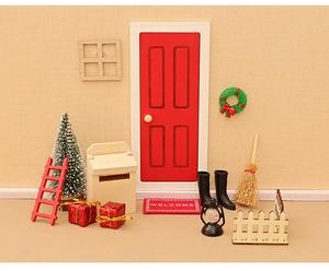Detailed miniature Christmas dollhouse set with red door, wreath, and tiny festive trees