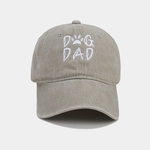Macro detail of DOG DAD embroidery and white paw print on washed cotton baseball cap