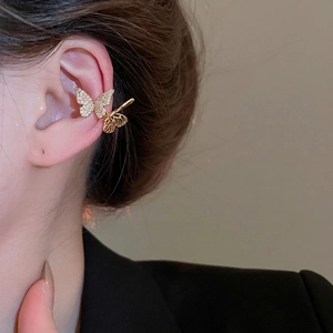 Elegant gold butterfly ear cuff with zircon crystals shown on model in a profile view