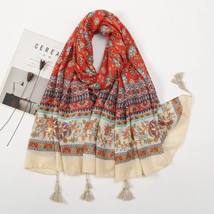 Bohemian floral printed shawl with tassels in vibrant red and blue hues on white background