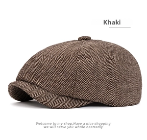 Detailed macro view of khaki herringbone tweed fabric on a classic newsboy flat cap
