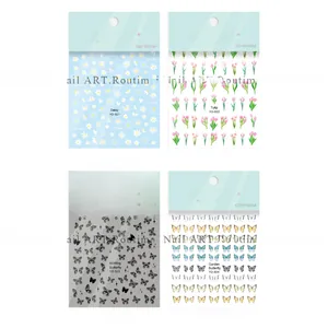 Macro detail of four floral and butterfly nail sticker sheets in diverse designs