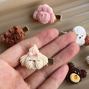 Detailed view of handmade puppy cookie hair clips in various colors with metal base