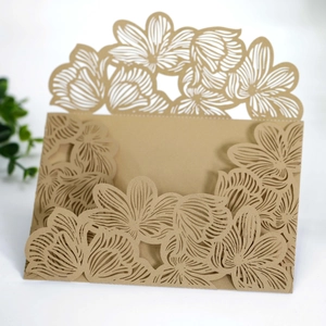 Close-up of laser-cut floral wedding invitation pocket in elegant kraft paper cardstock