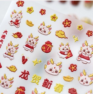 Macro detail of 3D embossed Lunar New Year nail stickers with cartoon dragon cats