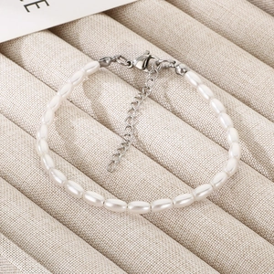 Detailed macro view of handmade pearl bracelet with stainless steel heart and clasp