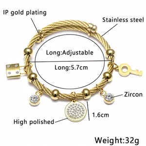 Bracelet ajustable en acier doré type câble avec breloques œil et verrou cœur