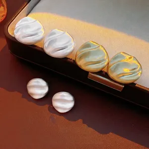 Elegant French style wavy geometric stud earrings in matte gold and silver finish