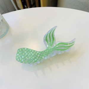 Pince à cheveux sirène en acrylique vert avec motifs écailles sur fond transparent