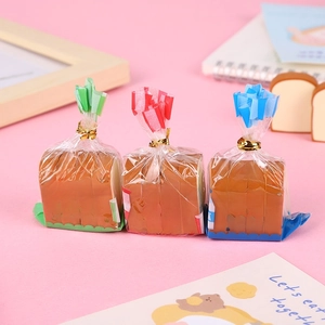 Detailed view of toast bread erasers in colorful packaging on a cute pink desk setup