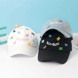 Detail of colorful letter embroidery on cotton kids baseball caps in various colors