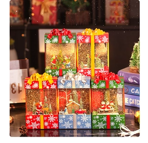 Luminous Christmas gift box water lanterns with festive scenes and swirling glitter